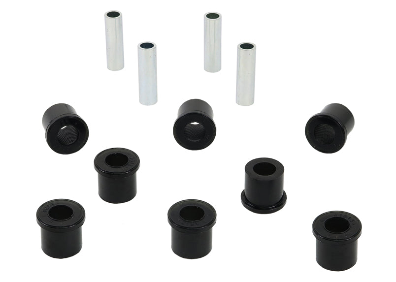 A set of black synthetic elastomer bushings and metal sleeves for vehicle control arms.