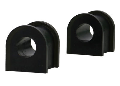 Two black rubber sway bar bushings on a white background