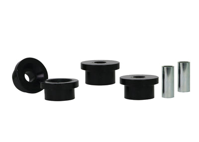 A set of black rubber bushings with metal sleeves for vehicle suspension systems.